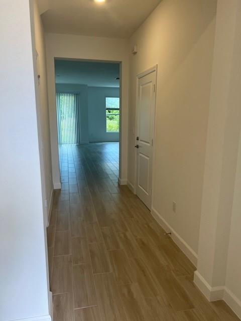 4393 Hammock Grove Drive Lake Worth, FL 33467 - Photo 12 of 32 a view of a hallway with wooden floor