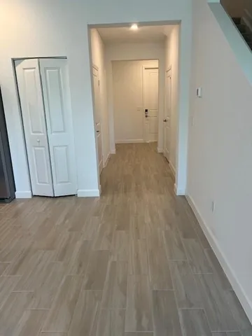 a view of a hallway with wooden floor