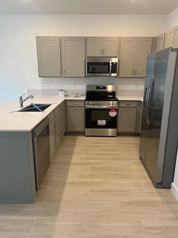 a kitchen with a sink a stove and a refrigerator