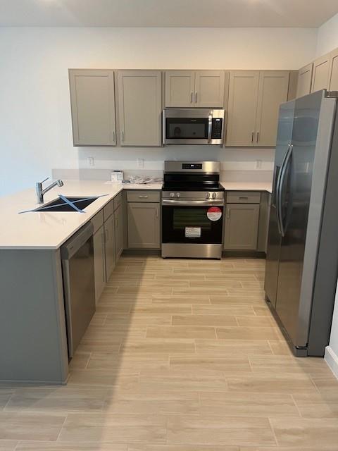 4393 Hammock Grove Drive Lake Worth, FL 33467 - Photo 14 of 32 a kitchen with a sink a stove and a refrigerator