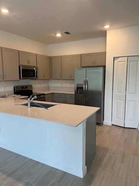 4393 Hammock Grove Drive Lake Worth, FL 33467 - Photo 16 of 32 a kitchen with stainless steel appliances a refrigerator and a stove top oven