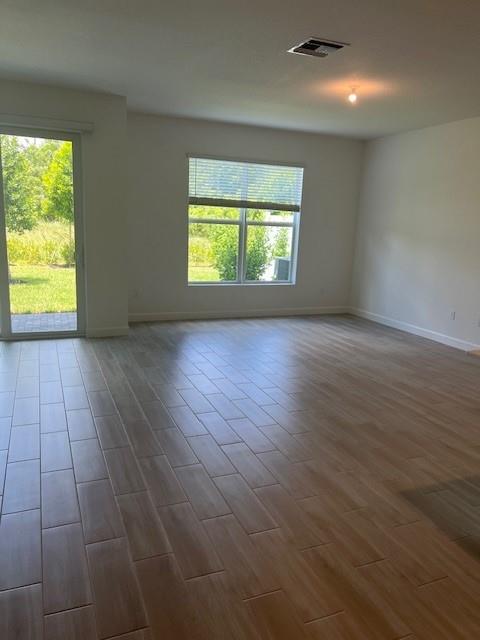 4393 Hammock Grove Drive Lake Worth, FL 33467 - Photo 21 of 32 an empty room with wooden floor and windows