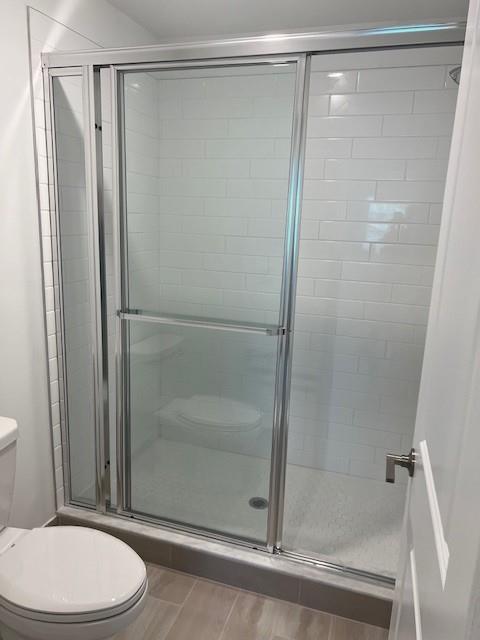 4393 Hammock Grove Drive Lake Worth, FL 33467 - Photo 28 of 32 a bathroom with a shower a toilet and a glass door shower