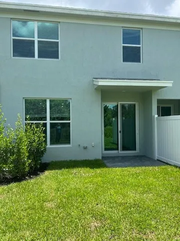 a view of house with backyard space and porch