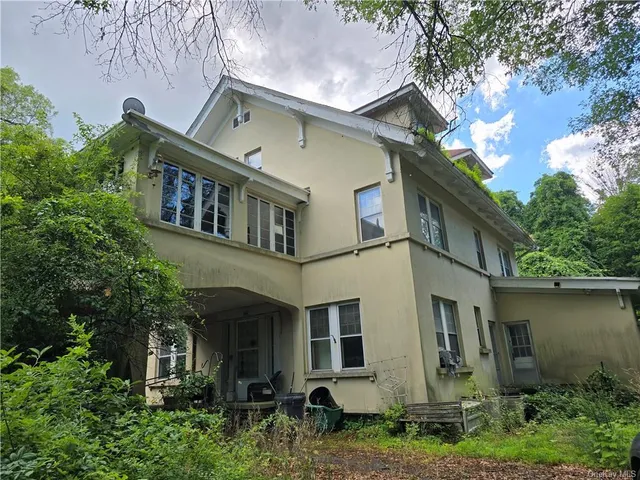 a view of a white building among the street side