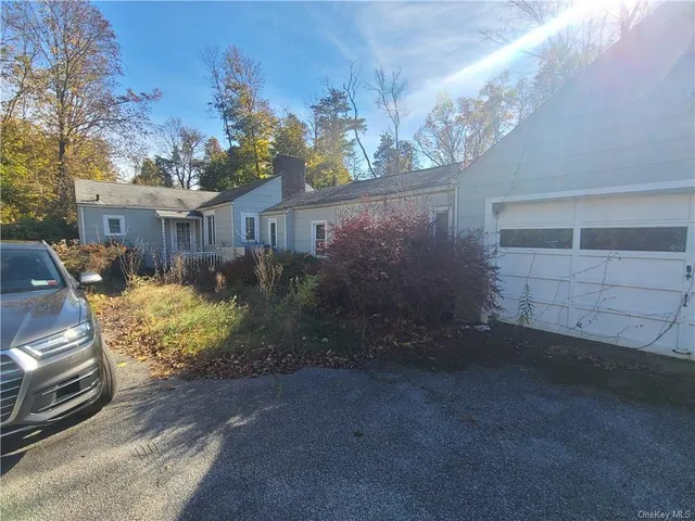a front view of a house with plants