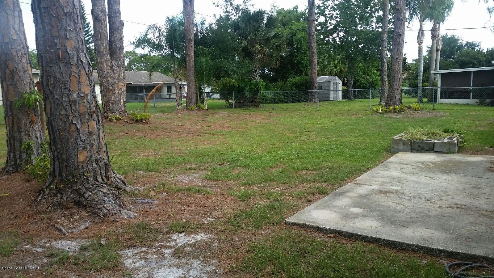 6940 Cairo Road Port St. John, FL 32927 - Photo 14 of 14 a view of a garden with a tree