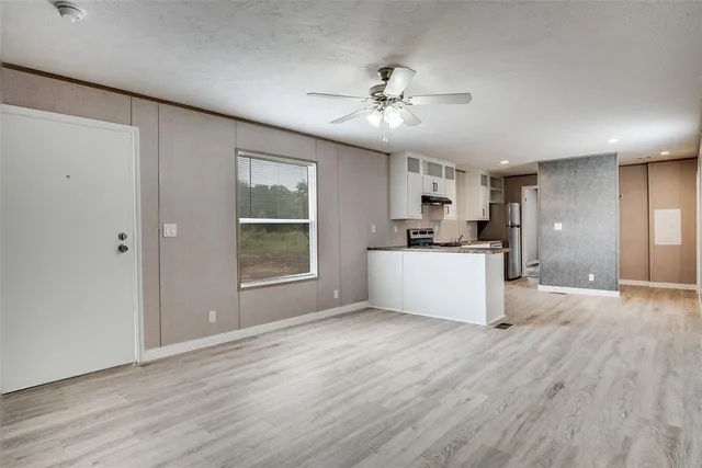 a view of a kitchen with a sink cabinets and wooden floor