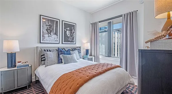 a bedroom with a large bed and a lamp