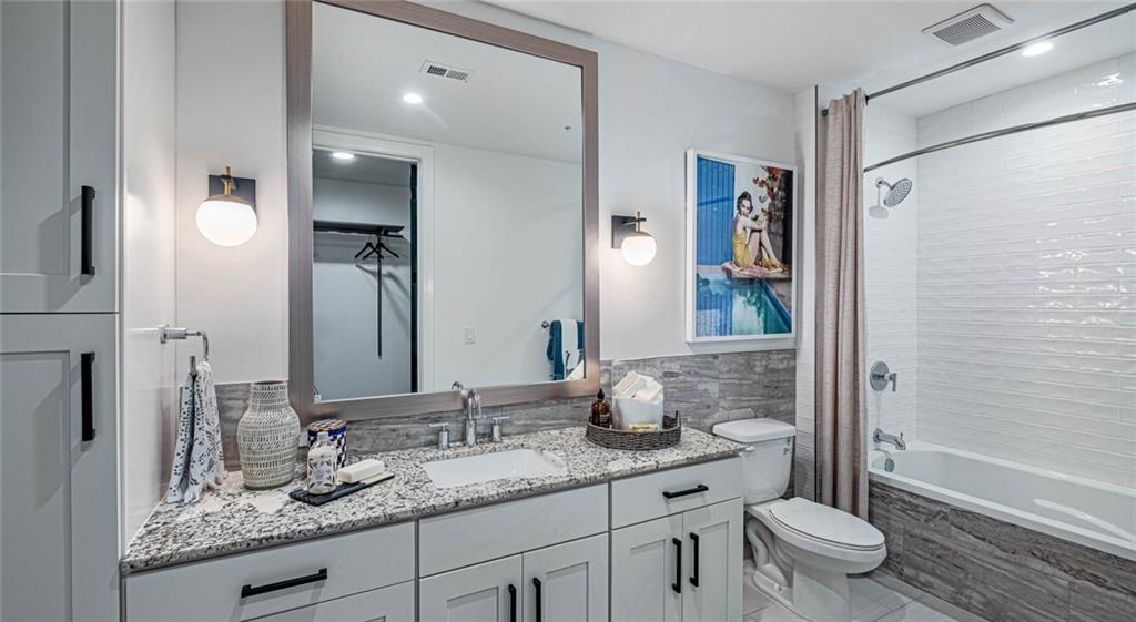 1301 Spring Street Northwest, Unit A3 Atlanta, GA 30309 - Photo 24 of 39 a bathroom with a granite countertop sink toilet and shower