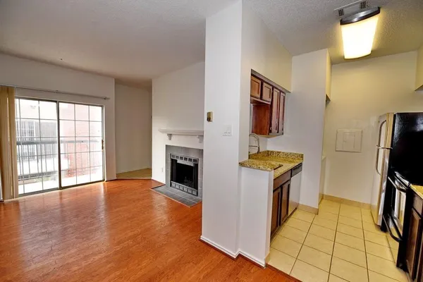 a view of kitchen with sink and refrigerator