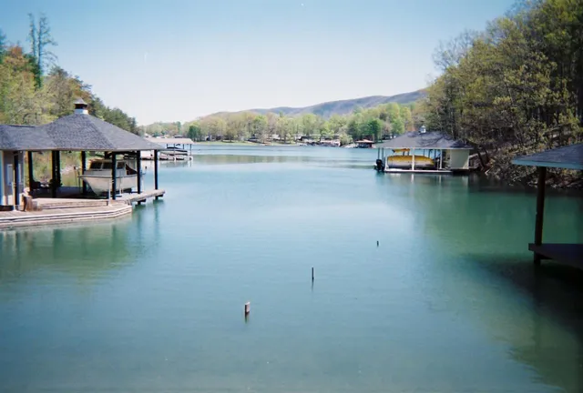 an aerial view of a house with a yard and lake view