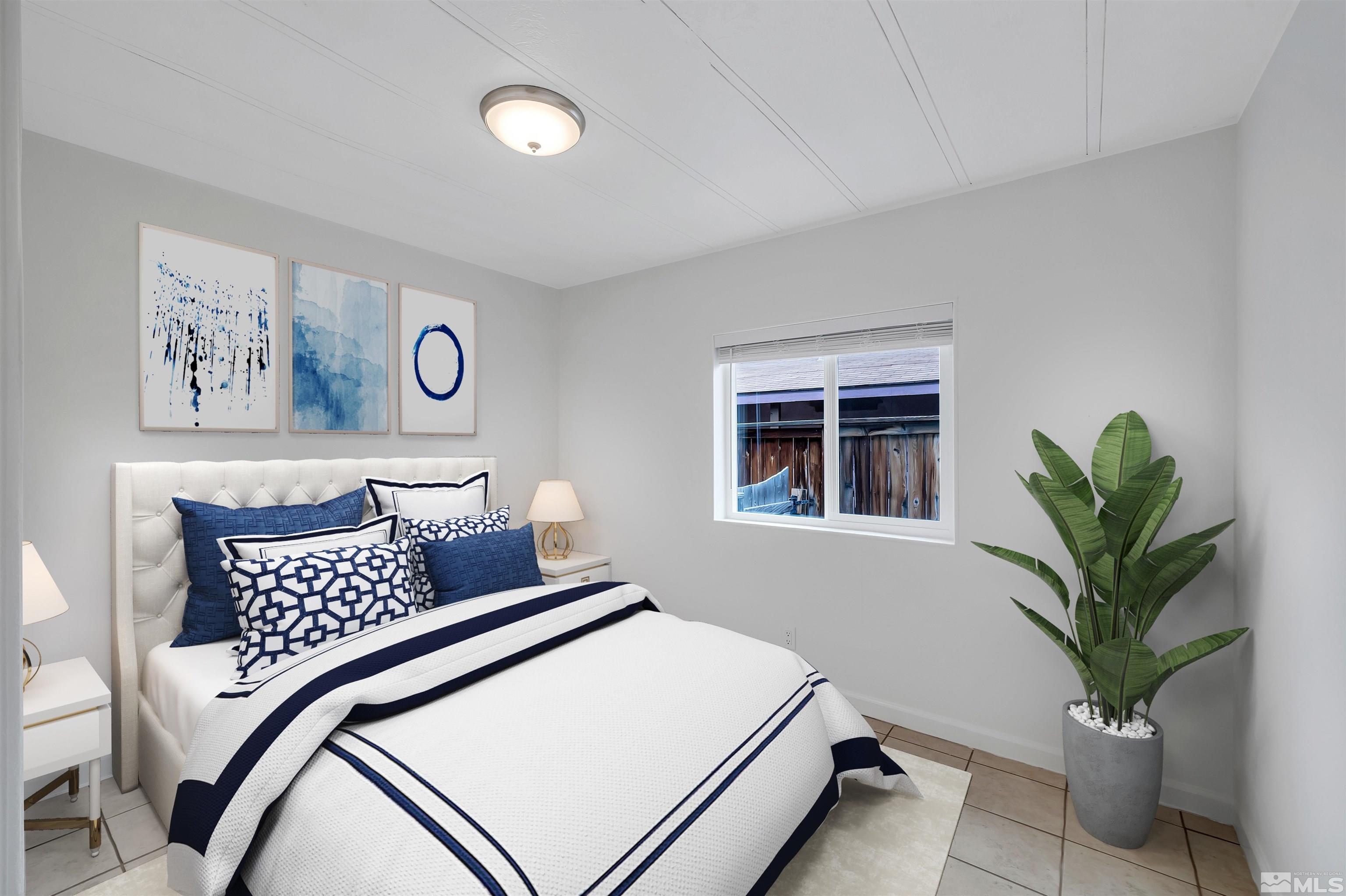 2177 Barberry Way Reno, NV 89512 - Photo 11 of 27 a bedroom with a bed and a potted plant