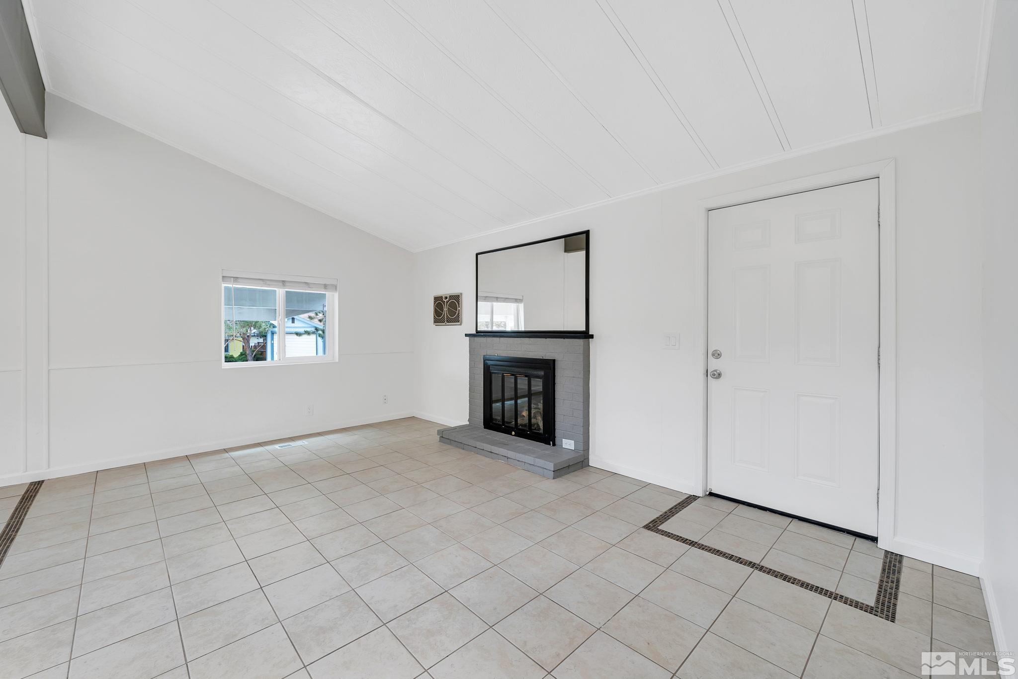 2177 Barberry Way Reno, NV 89512 - Photo 12 of 27 a view of a livingroom with an empty space and a fireplace
