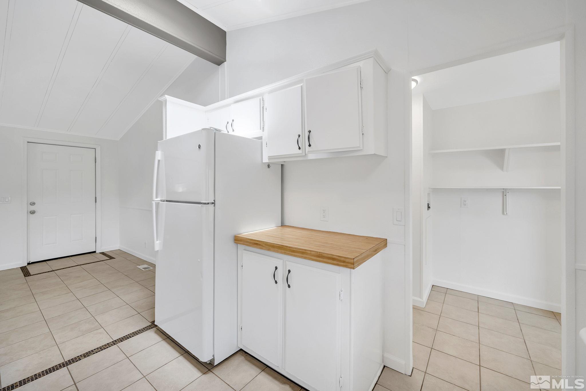 2177 Barberry Way Reno, NV 89512 - Photo 15 of 27 a kitchen with cabinets and a refrigerator