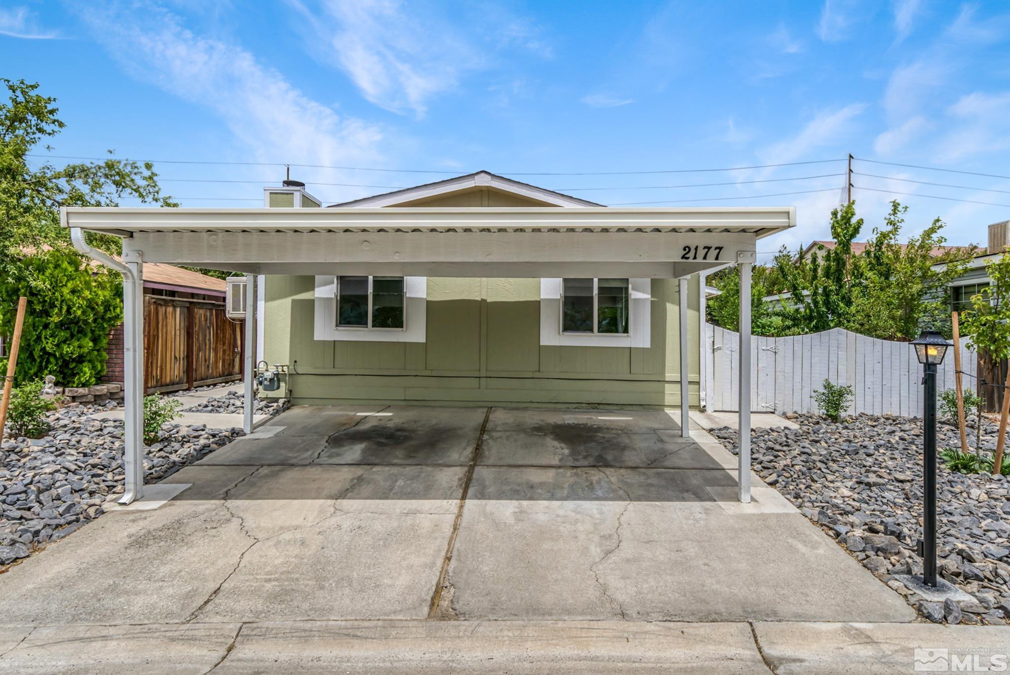 2177 Barberry Way Reno, NV 89512 - Photo 2 of 27 a front view of a house with a yard and garage