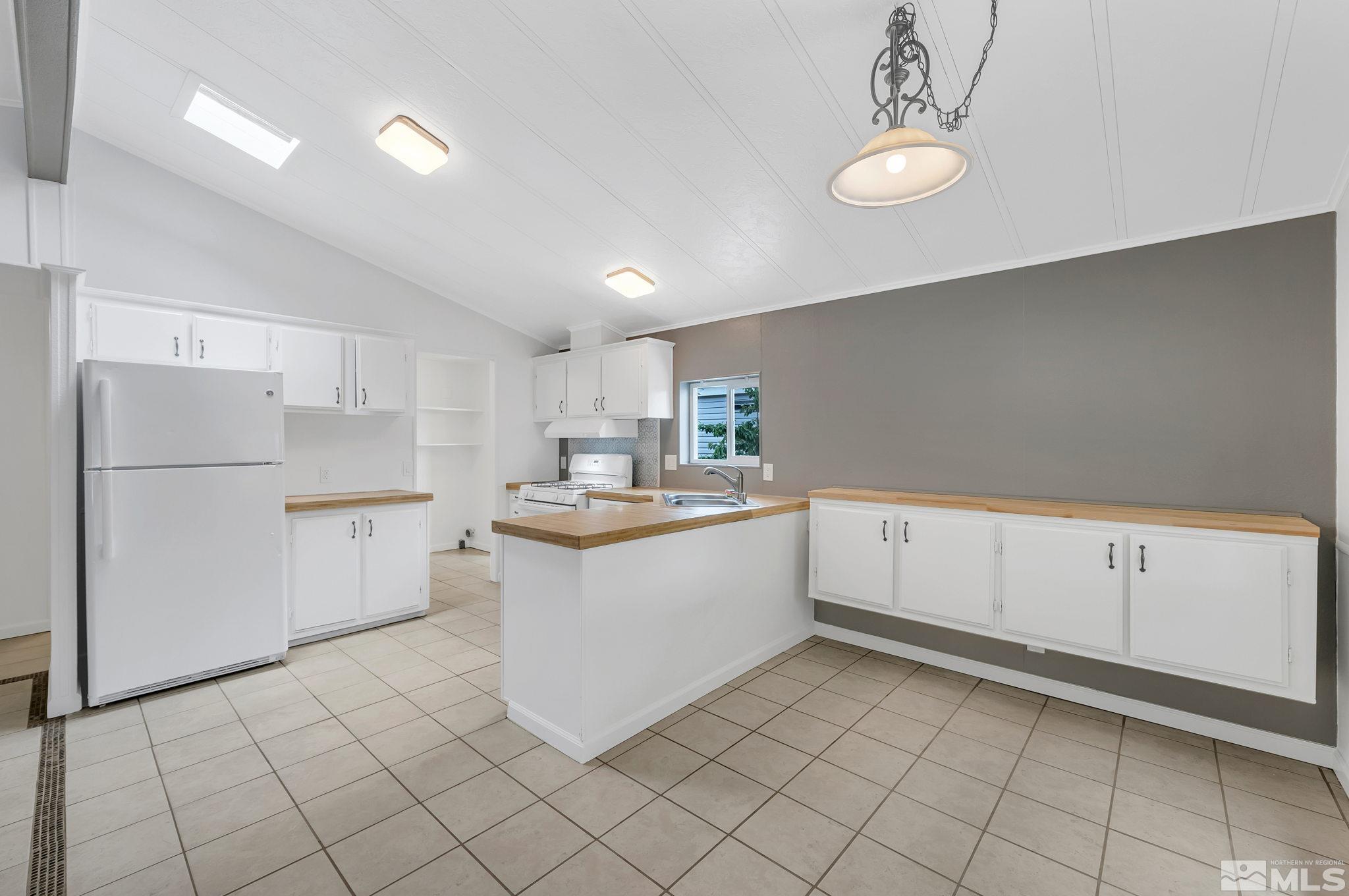 2177 Barberry Way Reno, NV 89512 - Photo 9 of 27 a kitchen with white cabinets and white appliances