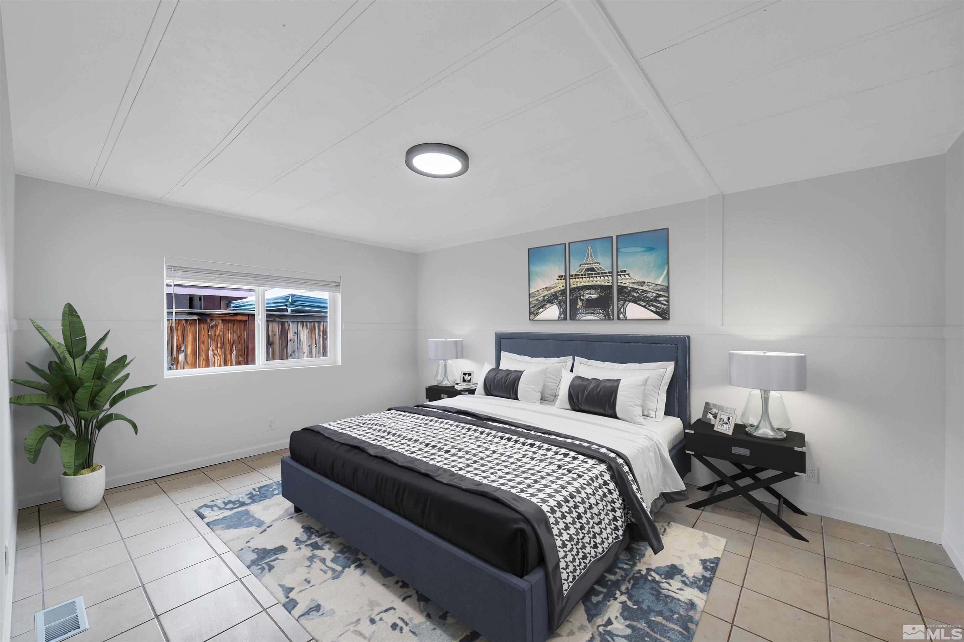 2177 Barberry Way Reno, NV 89512 - Photo 10 of 27 a bedroom with a bed and a potted plant