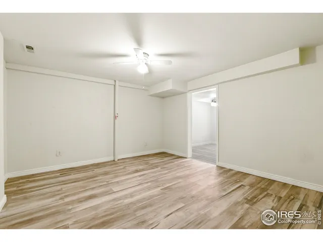 a view of a room with wooden floor