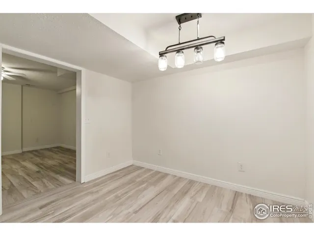 a view wooden kitchen with stainless steel appliances granite countertop a refrigerator and a wooden floor