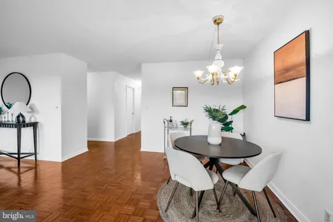 a view of a dining room with furniture and chandelier