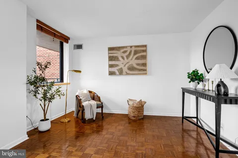 a living room with furniture and flowers