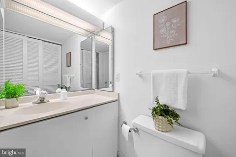 a bathroom with a sink mirror and vanity