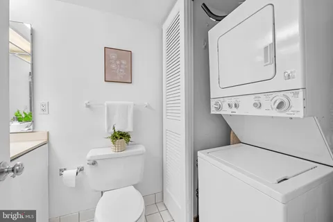 a white toilet sitting next to a bathroom sink