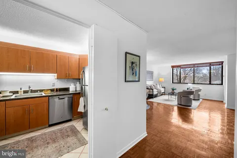 a kitchen with sink refrigerator and cabinets
