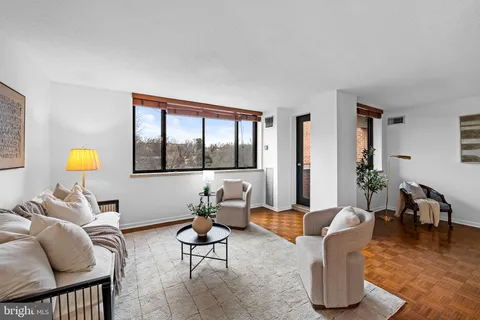a living room with furniture a window and a table