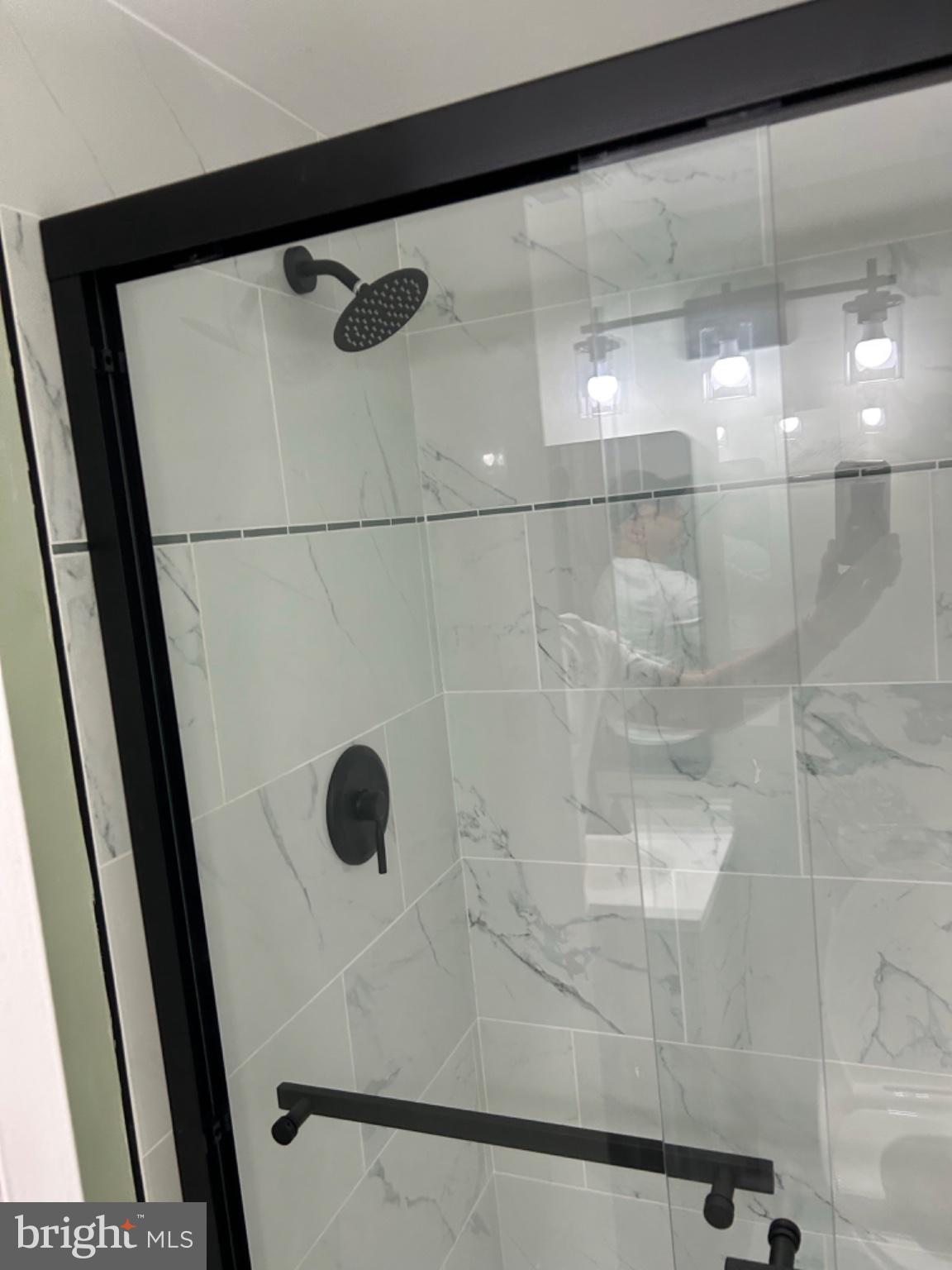 11609 Stoneview Square, Unit 11C Reston, VA 20191 - Photo 30 of 30 Sleek modern shower with elegant tiles.
