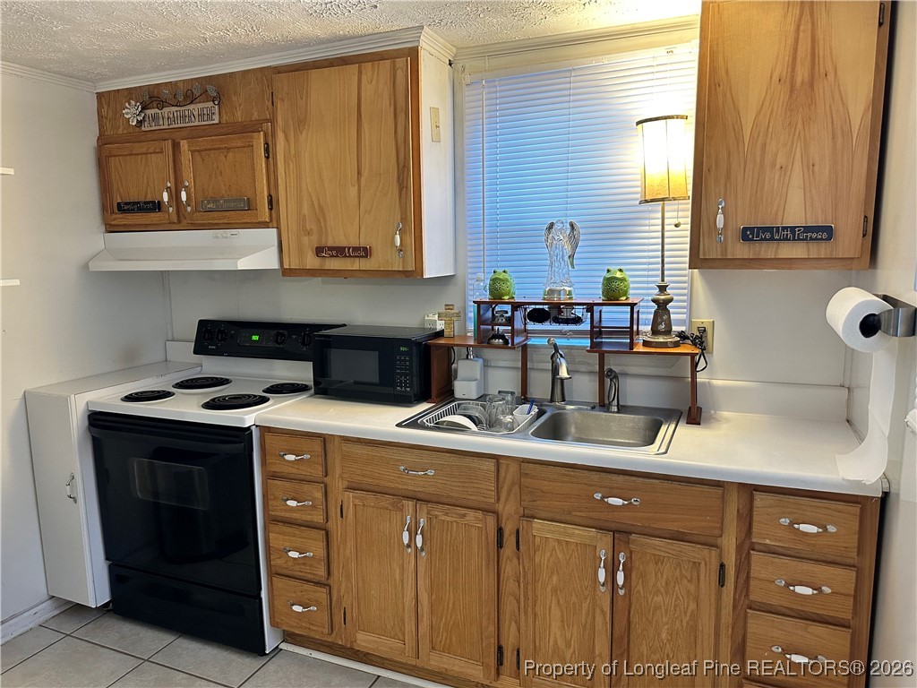 2986 Doc Brown Road Raeford, NC 28376 - Photo 3 of 14 a kitchen with stainless steel appliances granite countertop a sink stove and cabinets