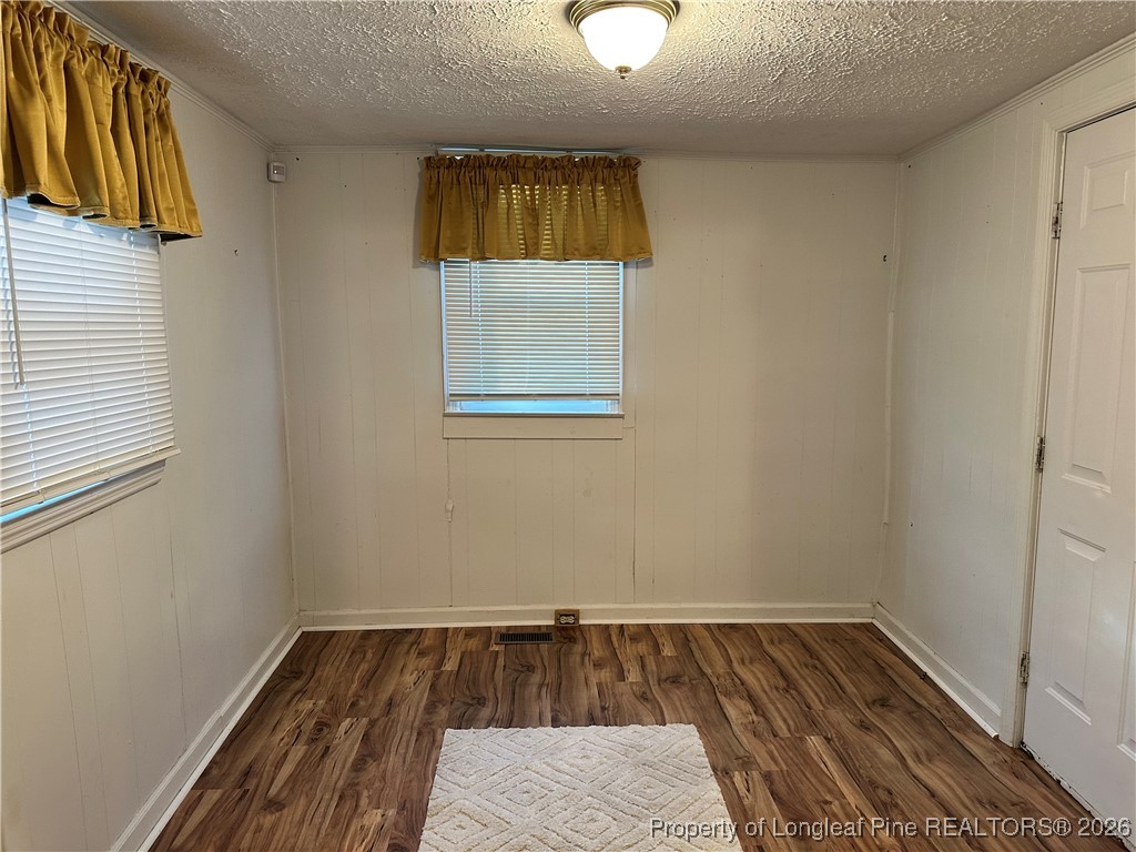 2986 Doc Brown Road Raeford, NC 28376 - Photo 9 of 14 an empty room with wooden floor and windows