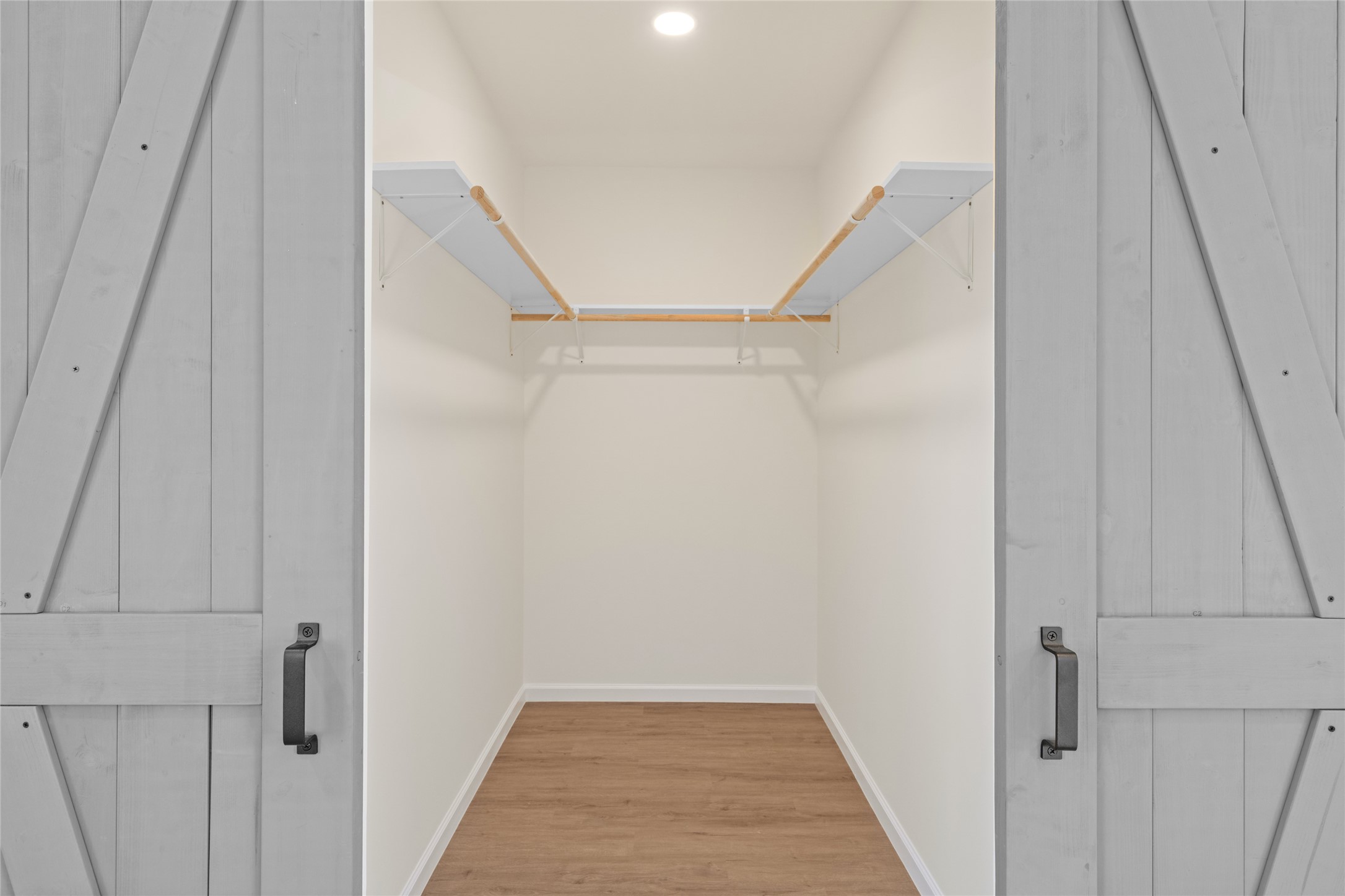 4656 North Teague Street Rosharon, TX 77583 - Photo 27 of 41 Walk-in closet with custom shelving—designed for organization and convenience.