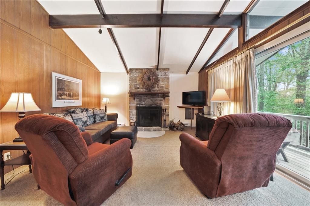 510 Forest Road Acme, PA 15610 - Photo 4 of 30 a living room with furniture a fireplace and a floor to ceiling window