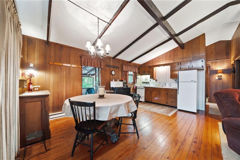 510 Forest Road Acme, PA 15610 - Photo 7 of 30 a view of a dining room with furniture window and wooden floor