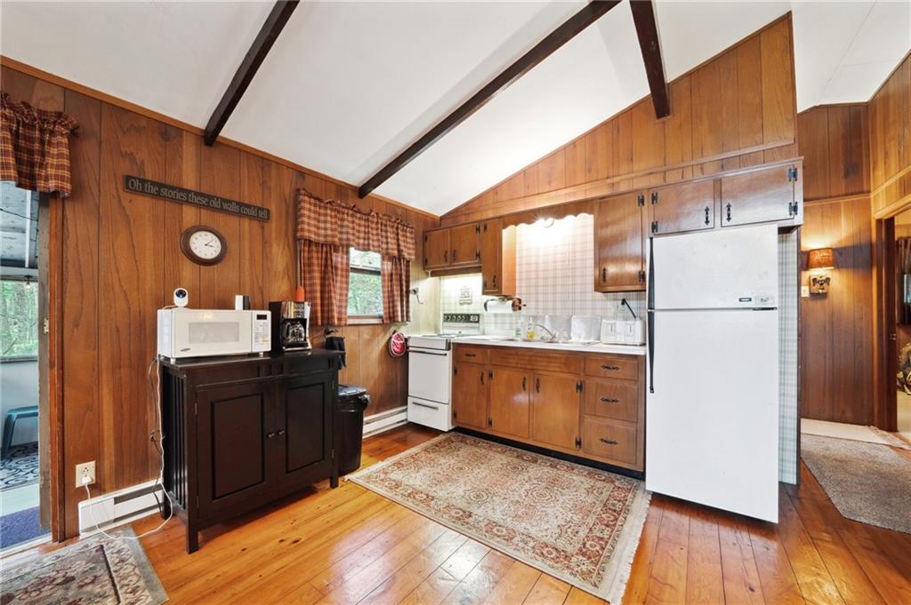 510 Forest Road Acme, PA 15610 - Photo 8 of 30 a kitchen with refrigerator cabinets and wooden floor