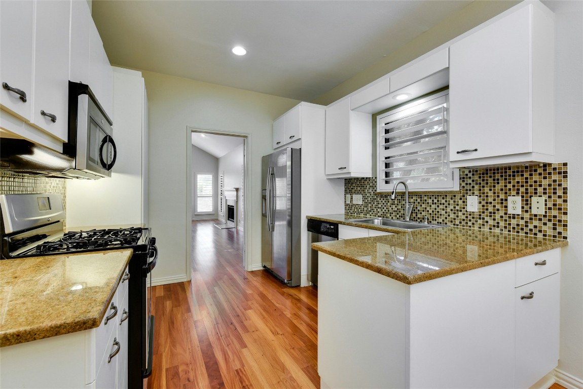3509 Fawn Trail Austin, TX 78746 - Photo 12 of 30 a kitchen with stainless steel appliances granite countertop a sink stove and refrigerator