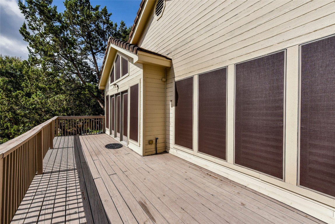 3509 Fawn Trail Austin, TX 78746 - Photo 22 of 30 a view of balcony with wooden floor and fence and a potted plant