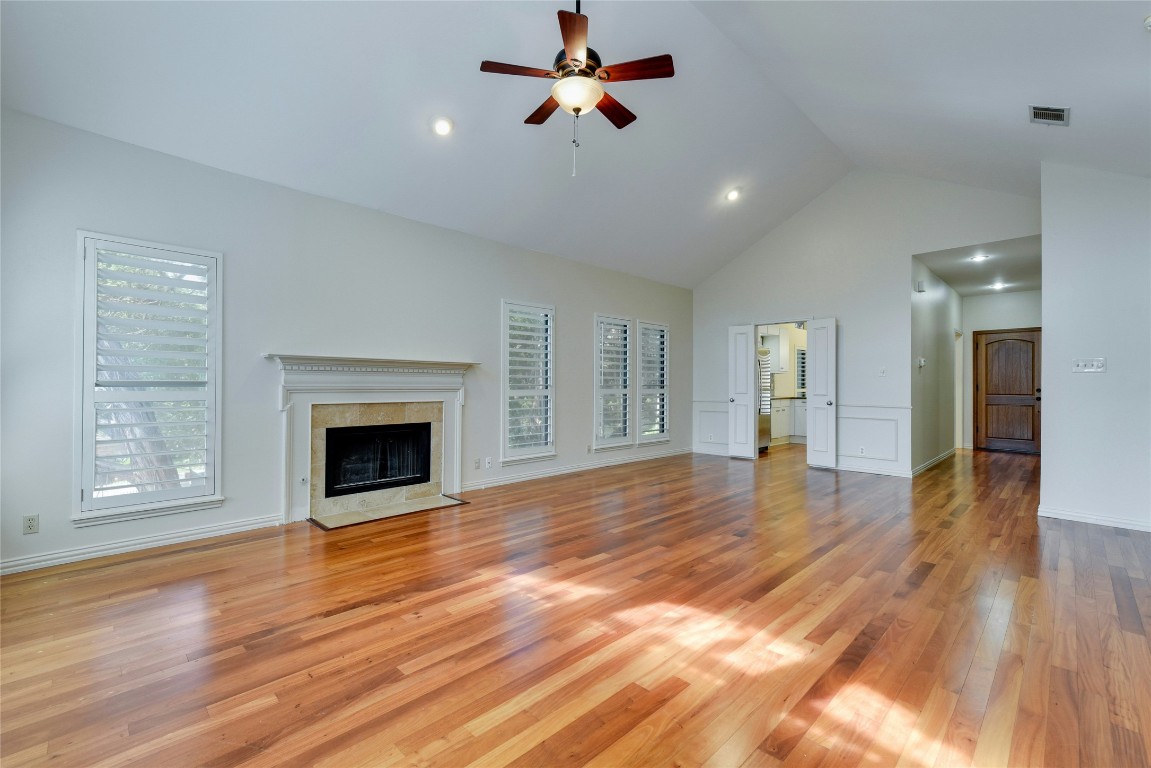 3509 Fawn Trail Austin, TX 78746 - Photo 8 of 30 a view of a livingroom with wooden floor a ceiling fan and windows