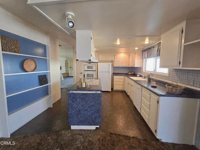a large kitchen with kitchen island a sink stainless steel appliances and cabinets
