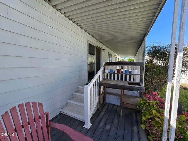 a view of balcony with furniture and wooden deck