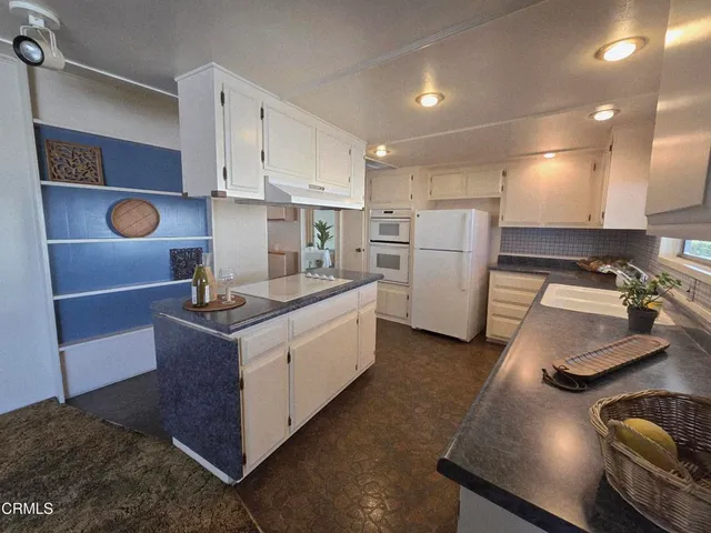 a kitchen with a sink cabinets and refrigerator
