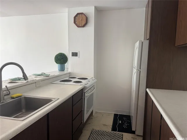 a kitchen with a sink cabinets and appliances