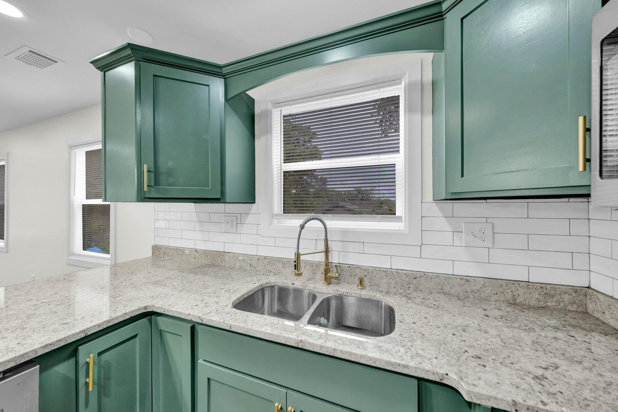 6681 Raleigh Millington Road Millington, TN 38053 - Photo 13 of 28 Kitchen with green cabinetry, tasteful backsplash, and light stone counters