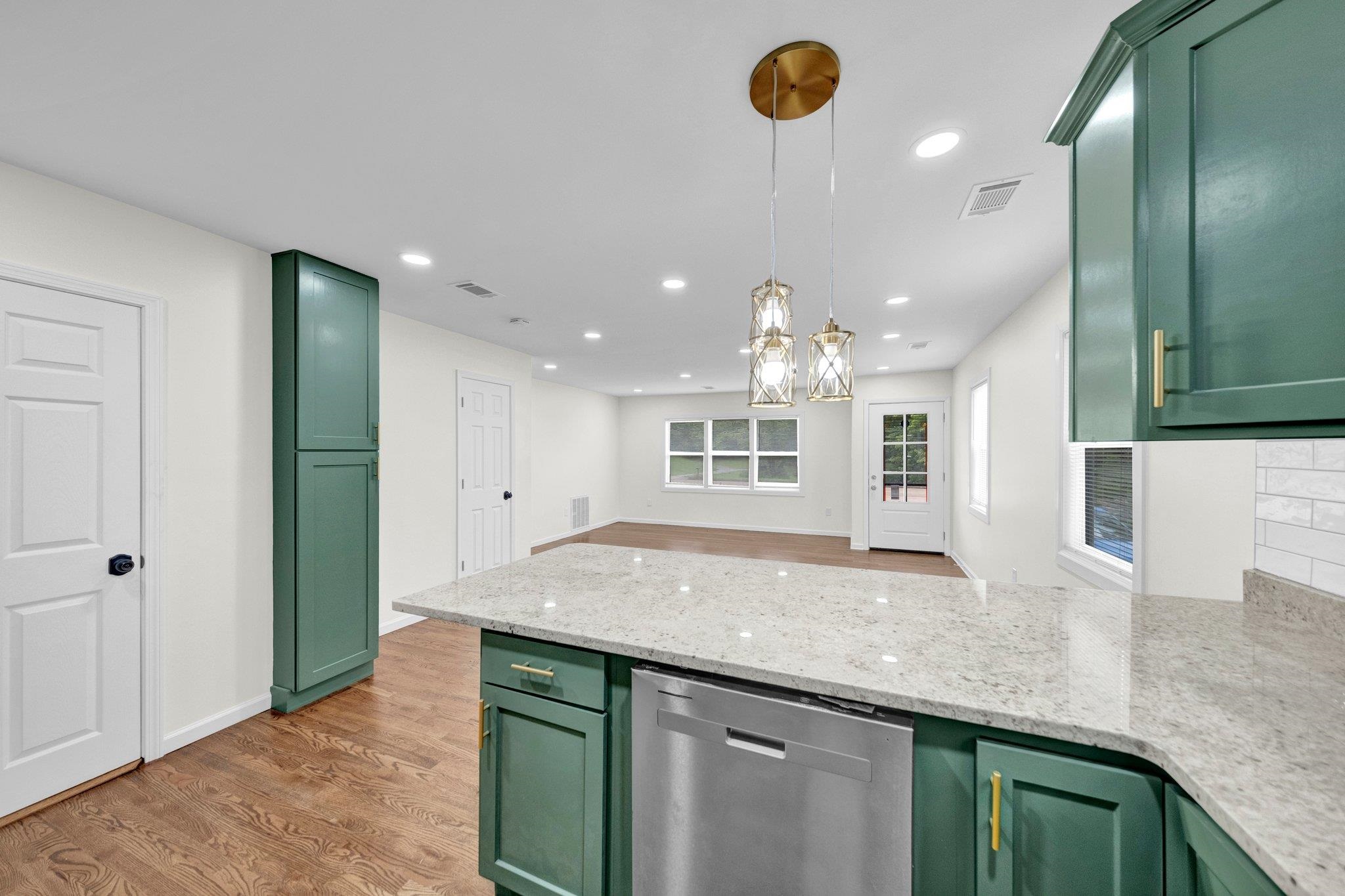 6681 Raleigh Millington Road Millington, TN 38053 - Photo 14 of 28 Kitchen with green cabinetry, dishwasher, a peninsula, light wood-style flooring, and hanging light fixtures