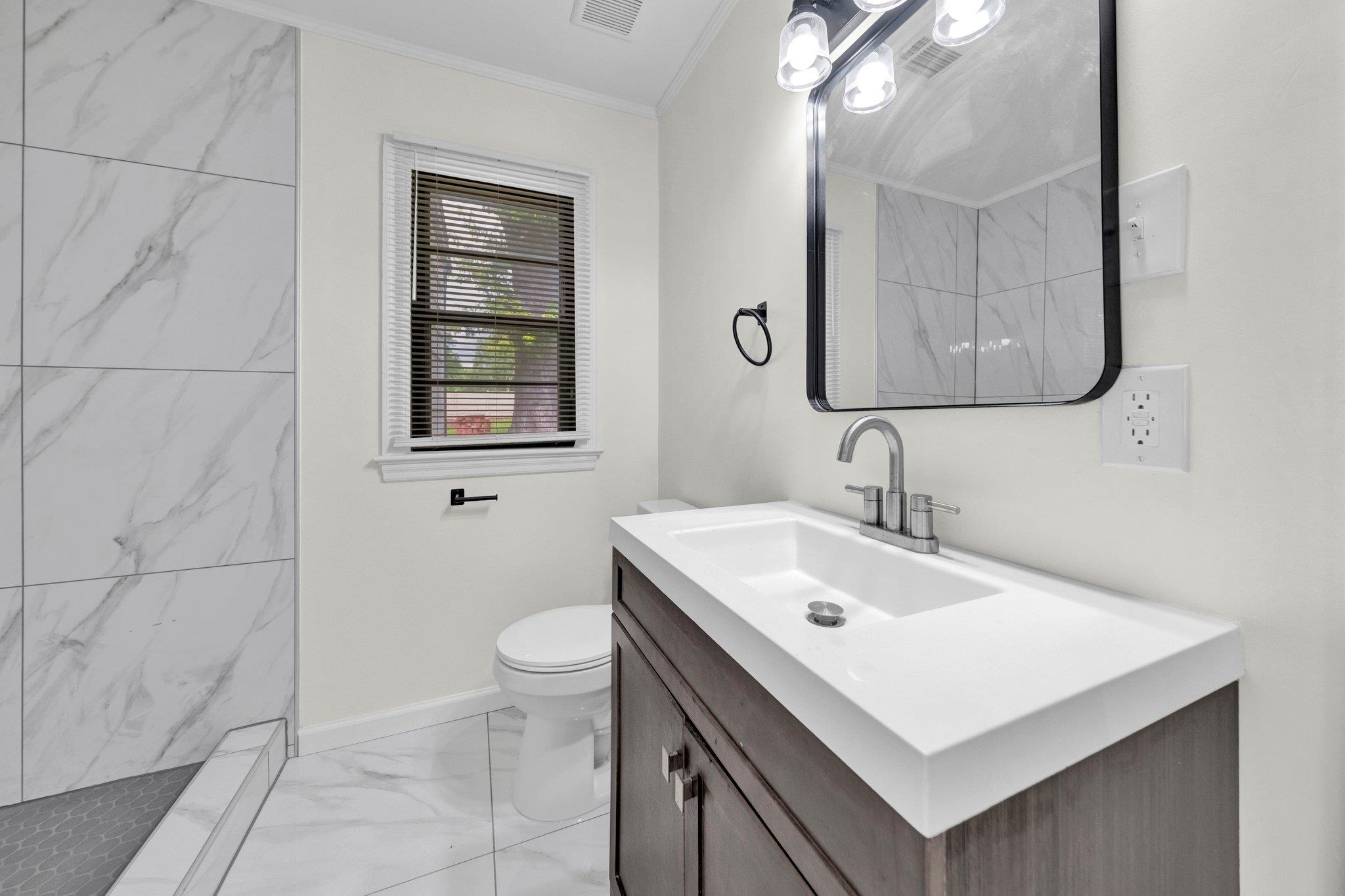 6681 Raleigh Millington Road Millington, TN 38053 - Photo 16 of 28 Full bathroom featuring marble look tiles, ornamental molding, vanity, and a marble finish shower