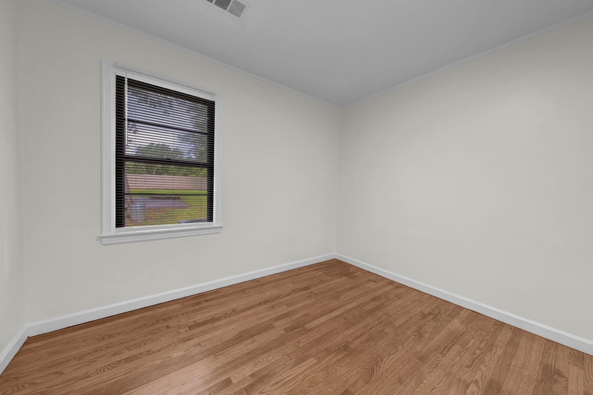 6681 Raleigh Millington Road Millington, TN 38053 - Photo 19 of 28 Empty room featuring wood finished floors and ornamental molding