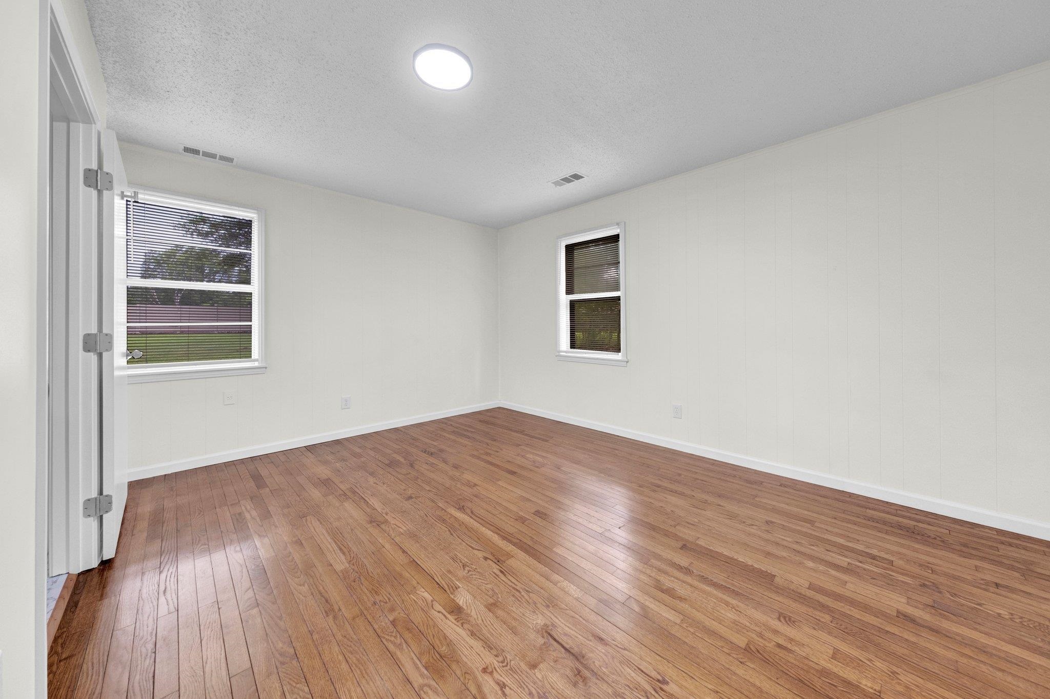 6681 Raleigh Millington Road Millington, TN 38053 - Photo 20 of 28 Spare room featuring hardwood / wood-style floors and a textured ceiling