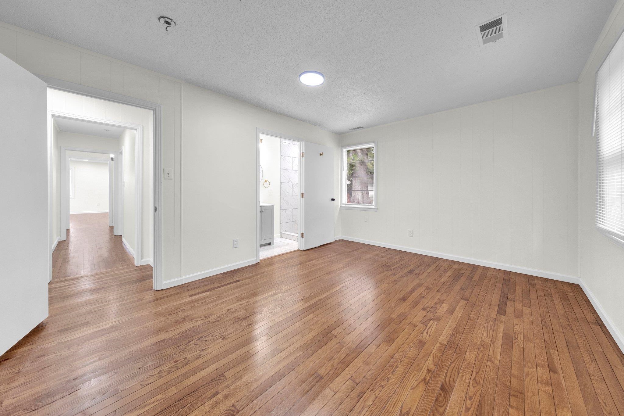 6681 Raleigh Millington Road Millington, TN 38053 - Photo 21 of 28 Spare room featuring hardwood / wood-style floors, a textured ceiling, and a pendent fire sprinkler